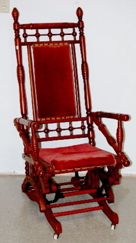Ornate Antique Mahogany Platform Rocker: Ornate Antique Mahogany Platform Rocker: stick, ball and beehive type design; upholstered seat and back rests, lower sides have spindles and carvings. *Please note, this item ships F.O.B. which means 