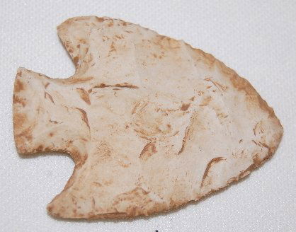 Corner Notched Point w/Square Stem: Corner Notched Point w/Square Stem: made from a light gray colored stone; the edges are fairly sharp; the tip comes to a broad point; one side of the stem is straight and the other is slightly curved.