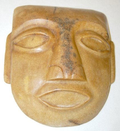 Carved Stone Mask with Elongated Ears: Carved Stone Mask with Elongated Ears: large oval eyes and smallish mouth; the flattened but well defined nose has a streak of natural darkness on its' full length; origin unknown. 8 1/8" L x 7 3/8" W