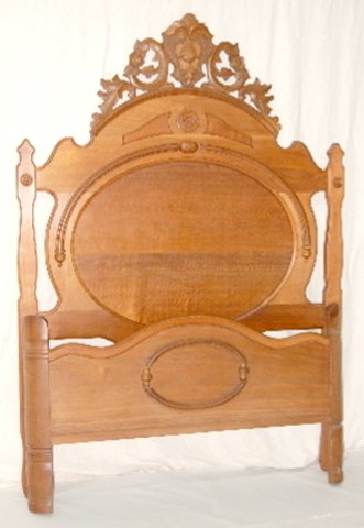 Carved Antique Walnut Bed w/Oval Panels: Carved Antique Walnut Bed w/Oval Panels: large oval panels; floral and nut carvings; carved corner posts on foot rail. 81" T x 56" W. *Please note, this item ships F.O.B. which means you, the buyer, m