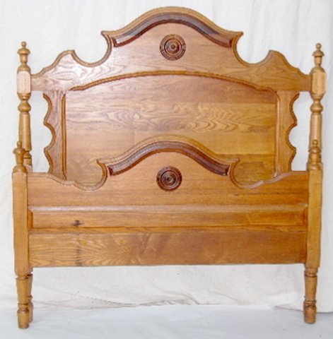 Antique Mixed Wood Bed: Antique Mixed Wood Bed: with finial carvings and walnut circles. 55" T x 50" W. *Please note, this item ships F.O.B. which means you, the buyer, must make all packing and shipping arrangements.*