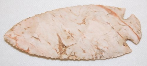 Notched Spear Blade, 4 3/8" Long: Notched Spear Blade, 4 3/8" Long: the notches are narrow and angled in from the corners; made of a stone with dark and light pink streaks and highlights; large flat flakes were removed from both sides