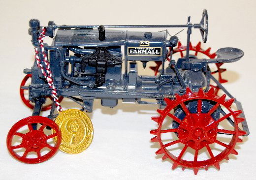 McCormick Deering Precision Toy Tractor: McCormick Deering Precision Toy Tractor: Precision Series; 1932 Farmall F-20; with medallion; has turning front wheels; like new. 5" x 8".