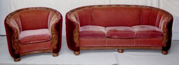 2 Piece Carved Karpen Art Deco Sofa Set: 2 Piece Carved Karpen Art Deco Sofa Set: floral carvings with 4 bands of wavy walnut surrounding the frame; carved bunn feet, wine upholstery with brass tack trim.*Please note, this item ships F.O.B.