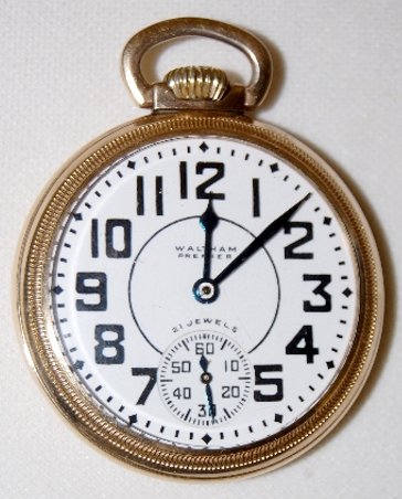 Waltham Premier 21J, 16S, OF Pocket Watch: Waltham Premier 21J, 16S, OF, LS, GF, SF & B Pocket Watch: adjusted temp; serial number 30707515. In a yellow 10K rolled gold plate Keystone Victory case numbered 4448334. The back has a train on it. 