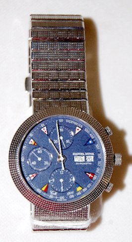 Daniel Mink Automatic Chronograph Wrist Watch: Daniel Mink Automatic Chronograph Wrist Watch: with a stainless steel band and a case with a dark blue, round dial. On the dial are 3 other dials, a day of the week and day of the month wheel at the 3