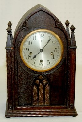 New Haven WM Chimes Cathedral Mantel Clock: New Haven Westminster Chimes Cathedral Mantel Clock: mahogany case; 4 carved columns; signed; 5 bar strike. 15 3/4" T. (Silvered dial; movement strike has some issues.)