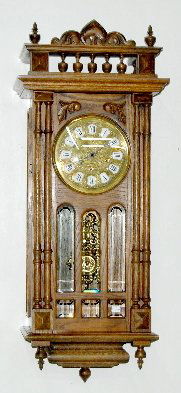 Gazo "San Marcos" Chiming Wall Clock: Gazo "San Marcos" Chiming Wall Clock: engraved dial, cartouche numerals, beveled glass, carved oak case, 3 train, fancy pendulum. 37"