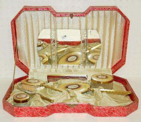 Celluloid Personal Care Set in Box: Boxed Dresser Set W/ Celluloid Inserts: center floral decoration; contains mirror; dresser boxes; comb, brushes w/ file and a hand held mirror. Nice condition.