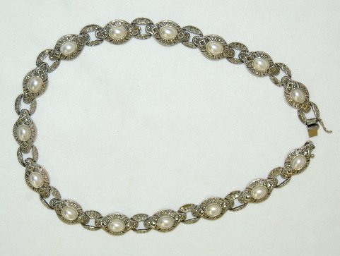 Sterling Silver & Marcasite Necklace & Bracelet: Sterling and Marcasite Necklace and Bracelet: both are Vintage Art Deco; the necklace is made of 15 segments with a white pearlized center surrounded by marcasites. It is 17" L; there are no missing p