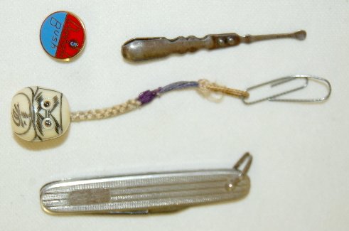 Sterling Pen Knife, Pin, Tweezers & Celluloid : Sterling Pen Knife, Pin, Tweezers & Celluloid Head: 1.) Sterling pen knife. 2.) Dunham Bush enamel pin, sterling. 3.) Ear wax & tweezer combination; old, steel. 4.) Celluloid head w/ protruding eyes.