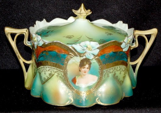 RS Prussia Mold #517 Decorated Cracker Jar: RS Prussia Mold #517 Decorated Cracker Jar: Ring mark on the bottom; molded floral edge with green, gold and brown bands with gold and gold floral decoration; a lower section of shaded green to brown;
