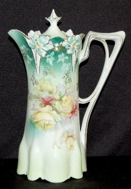 RS Prussia Mold #517 Floral Chocolate Pot: RS Prussia Mold #517 Floral Chocolate Pot: unmarked; molded flower rim with yellow roses on a shaded green to teal background with gold highlights and original lid. No condition problems. 10 1/2" T