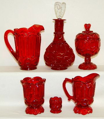 5 Pieces Ruby Moon & Star Glass, Pitchers, Bottle: 5 Pieces Ruby Moon & Star Glass: LE Smith Co. decanter w/ clear bottle; water pitcher; milk pitcher; covered candy; celery vase. No condition problems. Tallest 12"