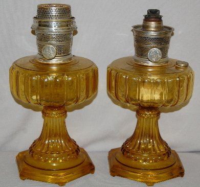 2 Aladdin B-109 Amber Beta "Cathedral" Lamps : 2 Aladdin B-109 Amber Beta "Cathedral" Lamps: one with a partial Model B burner, one with a complete Model B burner. 9" T (One missing fill cap.)