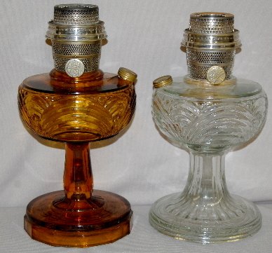 2 Aladdin B-39 & B-55 "Washington Drape" Lamps : 2 Aladdin B-39 & B-55 "Washington Drape" Lamps: 1.) B-39, clear with a round base and partial burner. 2.) B-55 Amber with a plain stem and Model B burner. 9" T No condition problems.