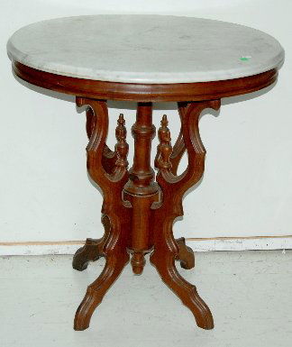 Antique Walnut Marble Top Parlor Table w/ Finials: Antique Walnut Marble Top Parlor Table w/ Finials: 4 center finials; acorn lower finial and oval white and gray beveled marble top. 29"T x 27 1/2"W x 22" deep. *Please note, this item ships F.O.B. whi