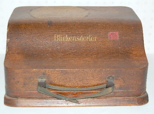 Antique Blickensderfer Model 7 Typewriter: Antique Blickensderfer Model 7 Typewriter, in a wood case. 7 1/2" x 13" (Leather strap is missing, water stains and veneer loss.)