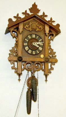 Carved Inlaid German 2 Weight Cuckoo Clock: Carved Inlaid German 2 Weight Cuckoo Clock: Carved with leaf decoration; has gong strike with bellows, has pendulum. Not tested. (There is one leaf missing off the crest.) 21" x 13"