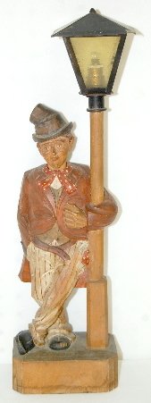Carved Wood Whistler Clock: Carved Wood Whistler Clock: A man in striped pants and a red coat is leaning against a lamppost; his head turns but he does not whistle; key is included. 18" T