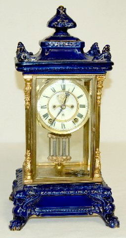Ansonia Porcelain Crystal Regulator #6 Clock: Ansonia Porcelain Crystal Regulator #6 Clock: 8 day, 1/2 hour gong; marked porcelain double sunk dial with Roman numerals and visible escapement; marked works; faux mercury pendulum; has key. (The clo