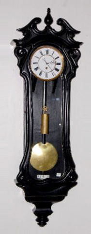 Serpentine Ebony Vienna Regulator Clock, TO: Serpentine Ebony Vienna Regulator Clock, TO: Porcelain dial with Roman numerals; 1 weight and pendulum; maker not known. Not tested. (Chip off the bottom knob; caulk holding the glass door in is deter