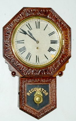 New Haven Octagon Regulator Clock "Branford": New Haven Octagon Regulator Clock "Branford": 8 day, TO, painted metal dial, oak case with pendulum and key. Not tested. 12" Dial; Clock is 27 1/2" x 17 1/2"