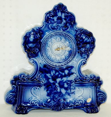 Flow Blue Porcelain Mantel Clock, England: Flow Blue Porcelain Mantel Clock, England: All porcelain case with molded dial Arabic numbers; works marked Smith Industries, England. Nice case. (Not running.) 15 1/2" x 14 1/2"