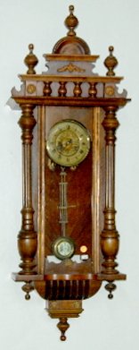 Junghans RA Time and Gong Strike Clock: Junghans RA Time and Gong Strike Clock: With decorated celluloid chapter ring and engraved floral dial; turned split column decorations in a nice veneer case with a stack crest. Not tested. 42" x 15".