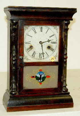 Gilbert "Paragon" Mantel Clock, 8 Day T & S: Gilbert "Paragon" Mantel Clock, 8 Day T & S: Has a painted metal dial, a painted and stenciled lower door with a stag, in a rosewood case with the pendulum. Not tested. (The dial is crazed.) 15" T