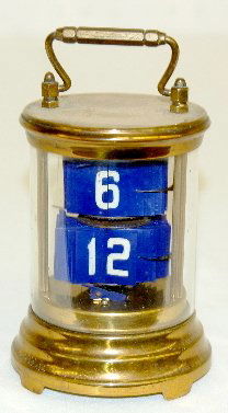 Plato Rotating Desk Clock, Round: Plato Rotating Desk Clock, Round: In a brass case with blue and white flag numbers. Not tested. (No key.) 6" x 3 1/2"