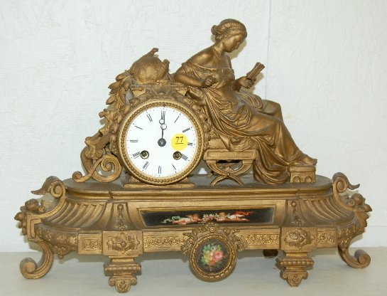 French Figural Clock, E. Pannard Pottellert Sue: French Figural Clock, E. Pannard Pottellert Sue: bell strike; no pendulum; porcelain insert w/ cherubs; lady reading a book; white metal case. 12" x 16" (Damaged figure above clock, as is.)