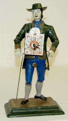 Metal Clock Peddler in Flat Hat: Metal Clock Peddler in Flat Hat: carrying a clock in front and on his back with pendulums dangling from his left hand; cast metal, not marked. 15 1/4" T