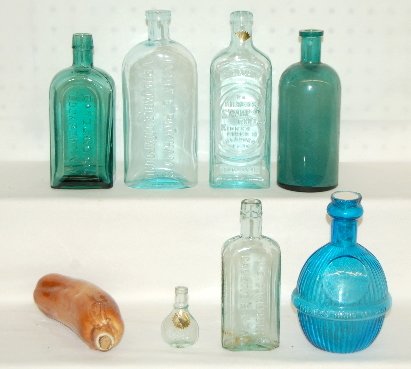 8 Antique Bottles, Medicine, Whiskey: 3 Antique Bottles, Medicine, Whiskey & Oil: 1.) China drawstring moneybag with a cork stopper. (Contained whiskey at one time.) 2.) Miniature flask marked NIPPON, has an S in a flower on the front. Ow