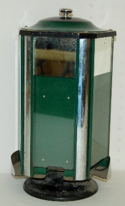 Antique Mirrored Counter Top Dispenser: Mirrored Counter Top Dispenser: deco; 4 sided w/ flat glass panels w/ chrome panels between them; 1/3 of the glass is mirrored; the metal parts are painted green or black; the top lifts up and exposes