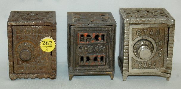 3 Cast Iron and Steel Safe Penny Banks: 3 Cast Iron and Steel Safe Penny Banks: 1.) "Star Safe" on the door, with a combination lock; filigree open top, plain sides and back; has the original finish with some wear. 2.) Kenton "Union Bank" o