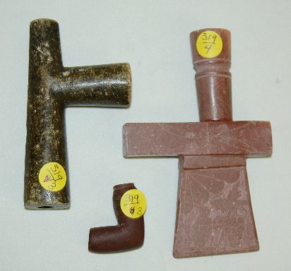 3 Native American Stone Pipe Heads: 3 Native American Stone Pipe Heads: 1.) Pink stone with one side etched with a cluster of grapes, an owl, a fan and leaves; it is shaped like a hatchet head. 2.) Grey stone cross shaped with an elonga