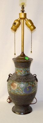 Champleve Enamel & Bronze Lamp: Champleve Enamel & Bronze Lamp: Japan with colored chrysanthemum flowers in the enamel decoration; has a white lamp shade held in place by a carved jade finial. 25 1/2" T