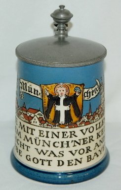 Mettlach #2002 Beer Stein, Munich & Verse: Mettlach #2002 Beer Stein: 1/2 liter; etched design of the town of Munich, a verse and a religious figure; marked with Castle mark, Mettlach VB, Ges Gesch. 2002 II.