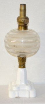 Civil War Era Atterbury Base Kerosene Lamp: Civil War Era Atterbury Base Kerosene Lamp: Has a milk glass base with a molded berry and leaf pattern; there is a brass collar; has a clear and frosted ring font; has a brass collar and a tall burner