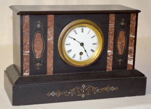 Boston Clock Co. Tandem Wind Shelf Clock: Boston Clock Co. Tandem Wind Shelf Clock: T.O.; porcelain dial; in a black slate and red marble case with beveled glass; with the key. (There are small chips to the case. There is also a corner chip.)