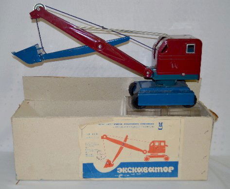 Russian Pressed Steel Toy Crane in Original Box: Russian Pressed Steel Toy Crane in Original Box: Tagged on the back; appears to be complete; has the original cardboard box. (The box is torn.) 8" x 19".