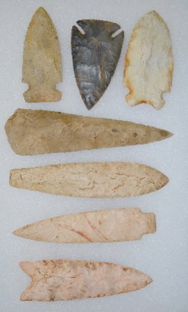 7 Native American Stone Points: 7 Native American Stone Points: 1.) Light tan with gray, Dalton type point; nice and thin with long chips removed from the center to the edge on both sides; there are fine serrations that form a sharp
