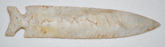 Native American Spear Point: Native American Spear Point: Made from a light gray material; long and narrow with side notches; the napper worked it so the nicks forming the edges join each other in the center; has a nice, thin poi