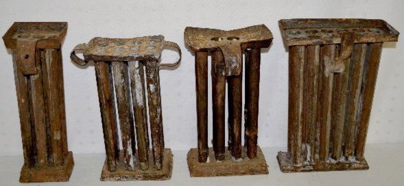 4 Antique Taper Candle Molds, 1800's, 6-12 Hole: 4 Antique Taper Candle Molds, 1800's, 6-12 Hole: 1.) 6 hole, 9 1/2" taper. 2.) 8 hole, 9" taper. (There are some candles in it.) 3.) 12 hole rectangular, 10" taper. 4.) 12 hole with a double handle, 9