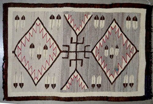 Old Navajo Wool Weaving, 55" x 36": Native American Weaving, 55" x 36": colors of brown, red, and tan; colors run light to dark; feather motif's are in diamond shapes with zig zag designs. Feathers are also around the edges. (Some wear 