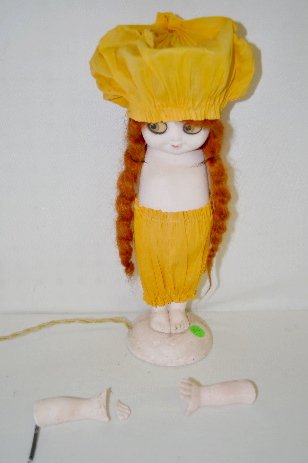 Chalk Carnival Doll Lamp, Electric: Chalk Carnival Doll Lamp, Electric: She has crepe paper clothes, the original wig and printed paper eyes. (One arm is detached.) 14" T Sells as is. **Please note, this item may be marked with a perman