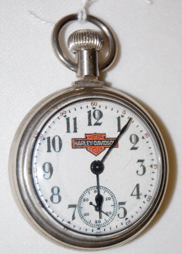 Westclox Harley Davidson Dollar Pocket Watch: Westclox Harley Davidson Dollar Pocket Watch: The dial has the 2nds bit and a Harley Davidson emblem; the case is engraved with a train engine. The watch is running at this time.
