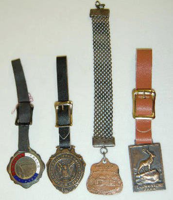 4 Watch Fobs - 3 Locations and U.S. Seal: 4 Watch Fobs - 3 Locations and U.S. Seal: 1.) "Yellowstone Park" showing a bull elk on a rock; copper colored; made by the Robbins Co. 2.) "Niagara Falls", red, white and blue enamel holds the words a