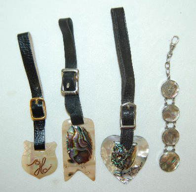 3 Watch Fobs and 1 Abalone Chain: 3 Watch Fobs and 1 Abalone Chain: 1.) Formed as a heart with Long Beach, Calif. written in black paint. 2.) A long rectangle with a "V" notch. 3.) Shield shaped with a letter "H", made of gold plated